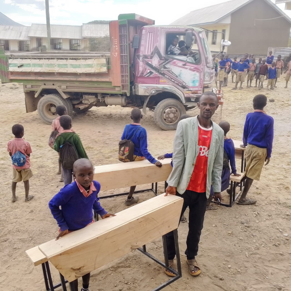 School Desks for Maasai Students Students receiving new classroom desks in Tanzania
